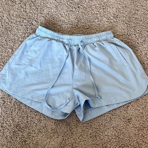 Light blue athletic shorts, size medium
